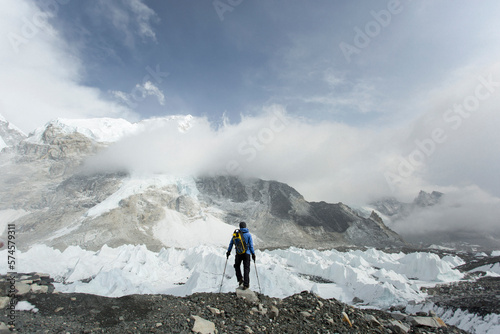 A trekker stands over the Khumbu Glacier in Everest Base Camp. photo