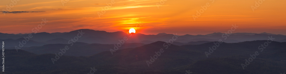 Panoramic view from Buck Mountain summit at sunset with Gore Mountain visible, Adirondack Mountains, New York State, USA