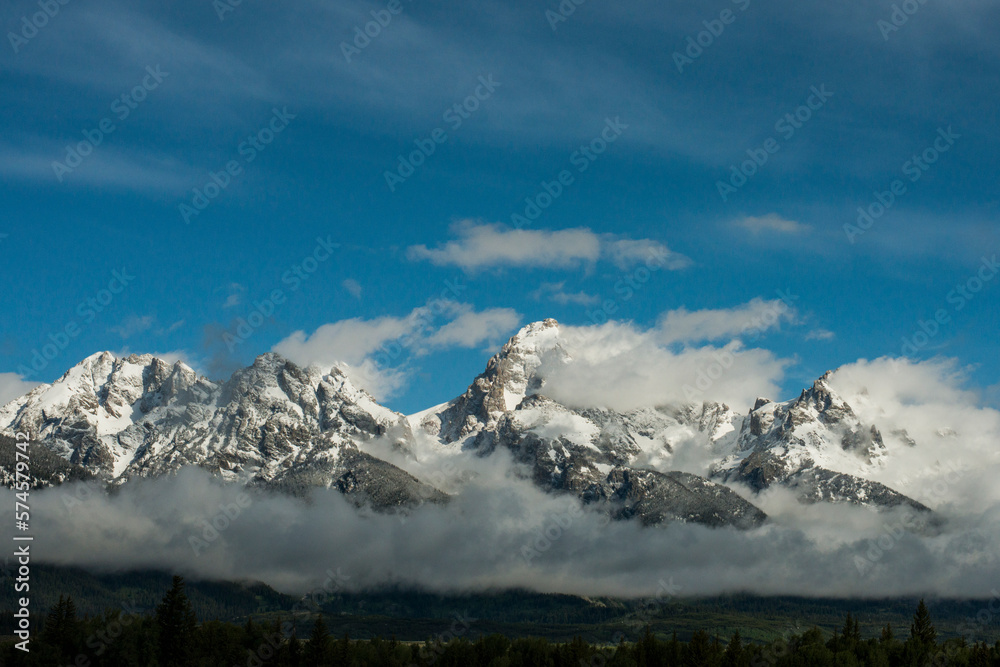 Early spring snow capped peaks and storm clouds over the Teton range in Grand Teton National Park, Wyoming. Early spring snow capped peaks and storm clouds over the Teton range in Grand Teton National Park, Wyoming.