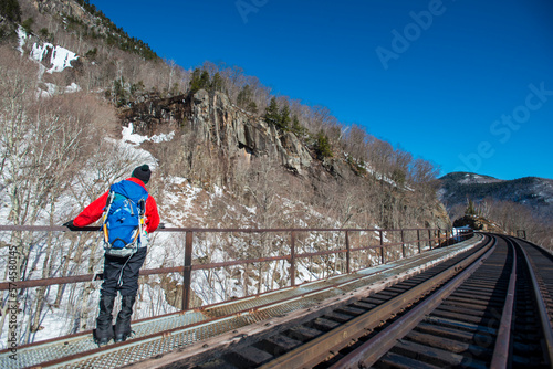 Ice climber hiking on warm winter day, Crawford Notch, New Hampshire, USA photo