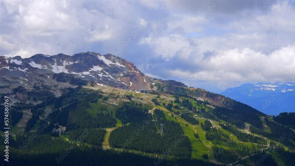 Establishing shot of majestic mountains with forest foreground in Vancouver, Canada, North America. Day time on September 2022. Still camera view. ProRes 422 HQ. Establishing shot of majestic mountains with forest foreground in Vancouver, Canada, North America. Day time on September 2022. Still camera view. ProRes 422 HQ.