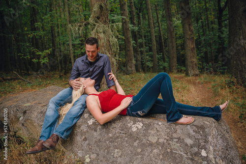 Portrait of blonde woman lying in man's lap in forest, Eugene, Oregon, USA photo