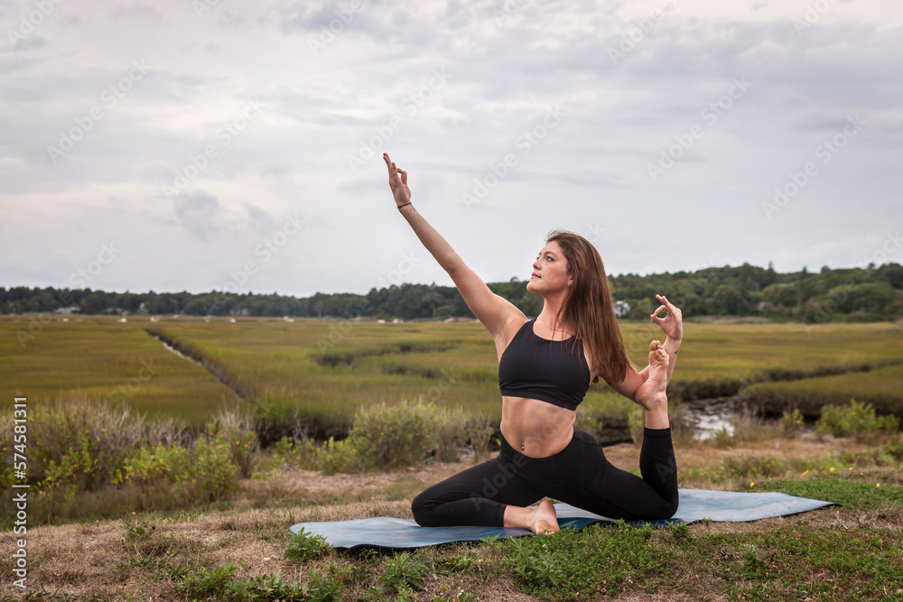 Women in king pigeon yoga pose Women in king pigeon yoga pose