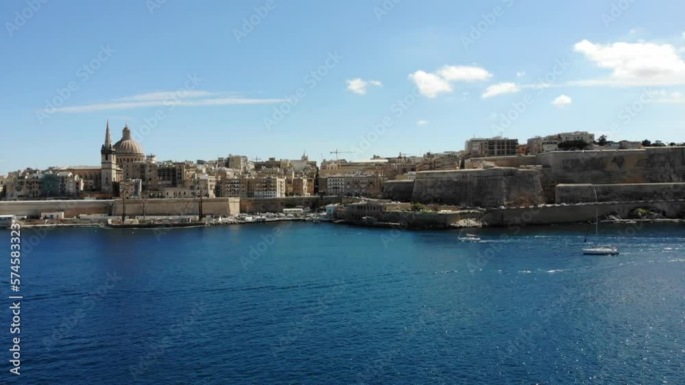 Valletta mediterranean capital city of Malta island skyline from harbour with blue sea and yacht on sunny summer day Valletta mediterranean capital city of Malta island skyline from harbour with blue sea and yacht on sunny summer day