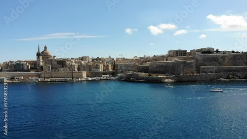 Valletta mediterranean capital city of Malta island skyline from harbour with blue sea and yacht on sunny summer day photo