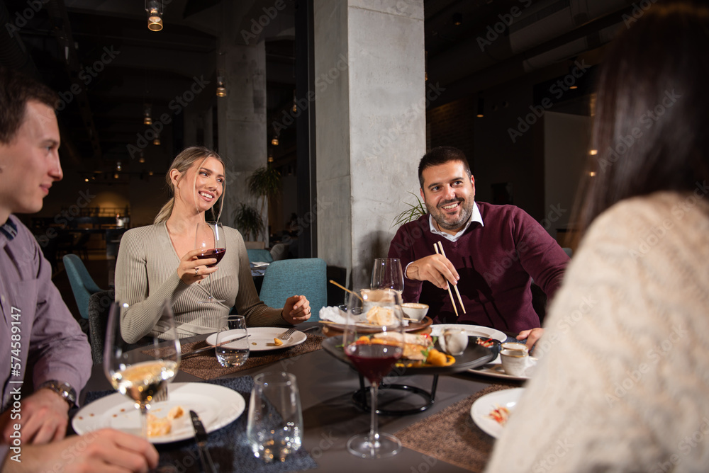 Group of Happy friends having dinner in the restaurant