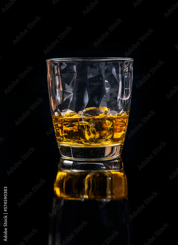 Whisky glass with ice on black background Whisky glass with ice on black background