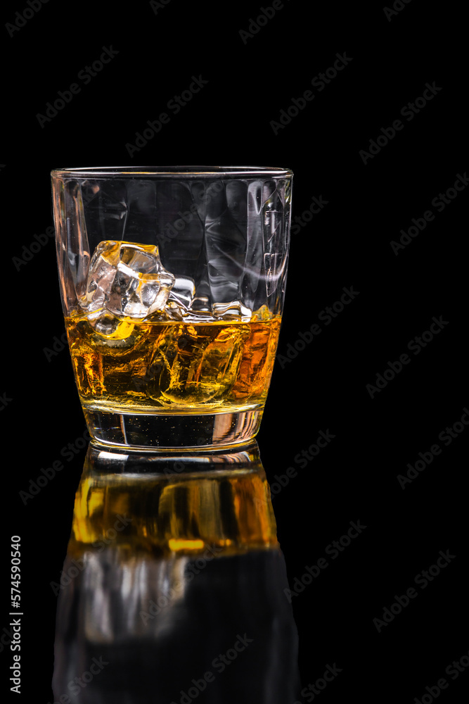Whisky glass with ice on black background Whisky glass with ice on black background