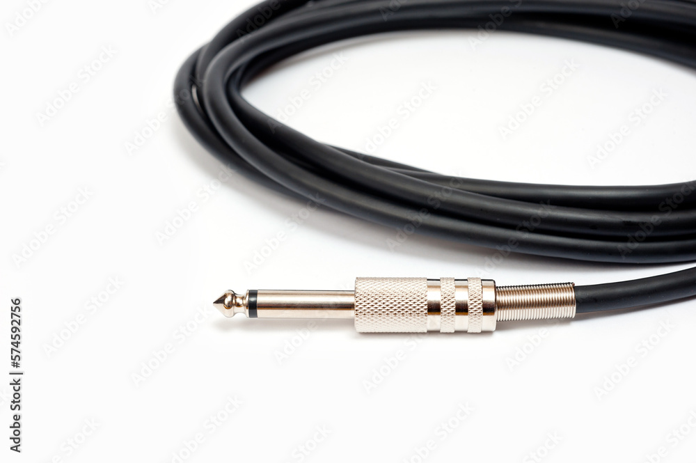 Long black jack cord for electric guitar, filmed on a white background.