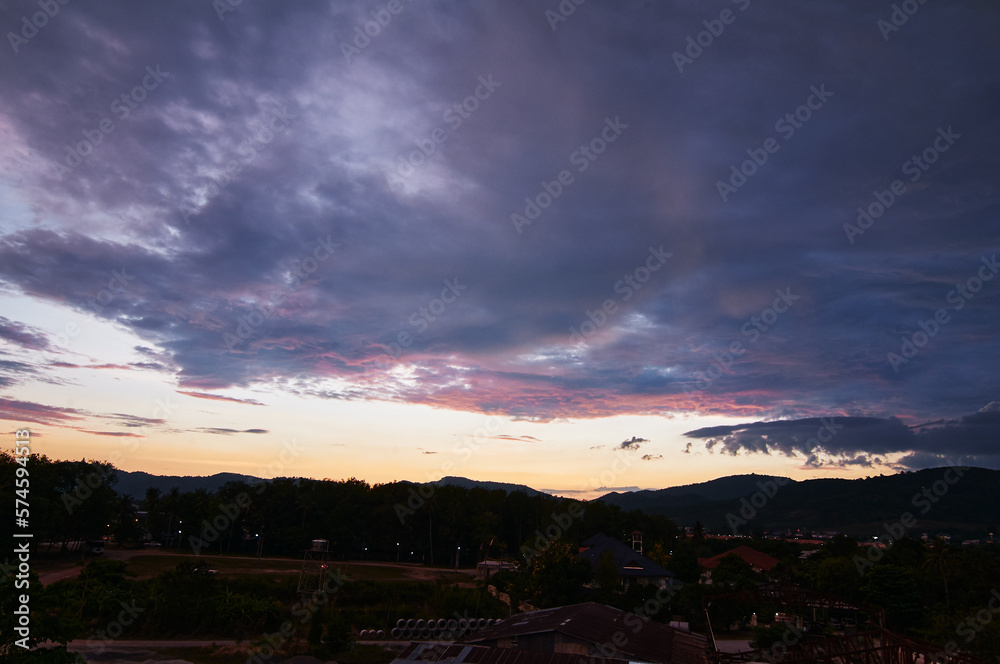 Fototapeta premium Dramatic landscape with view on evening city. Beautiful cloudy sky.