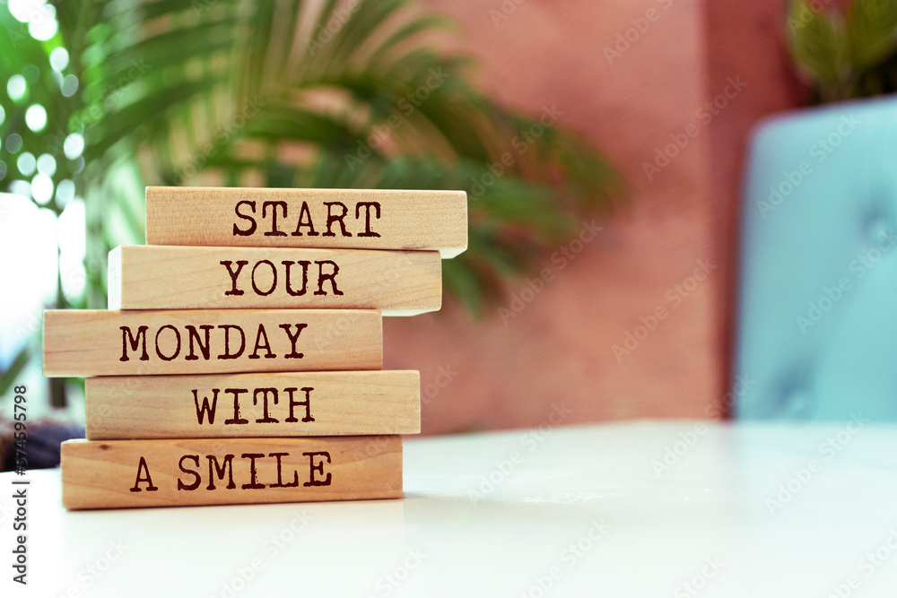Wooden blocks with words 'Start your Monday with a smile'. Wooden blocks with words 'Start your Monday with a smile'.