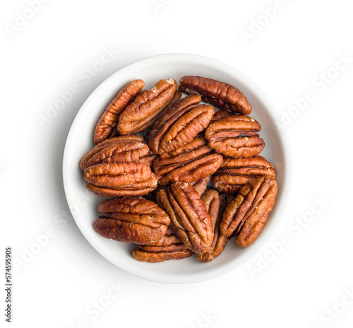 Peeled pecan nuts in bowl isolated on white background.