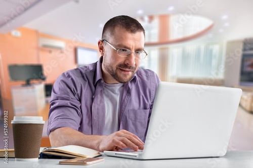 Busy young business man worker typing on laptop