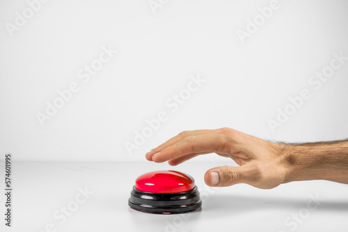 Fotografie Hand Deciding Whether to Press the Big Red Button