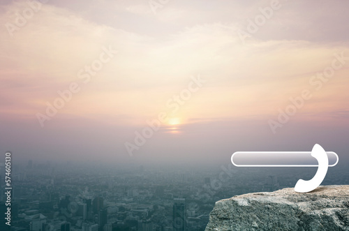 Phone icon with copy space for add your phone number on rock mountain over aerial view of cityscape at sunset, vintage style, Business contact us concept