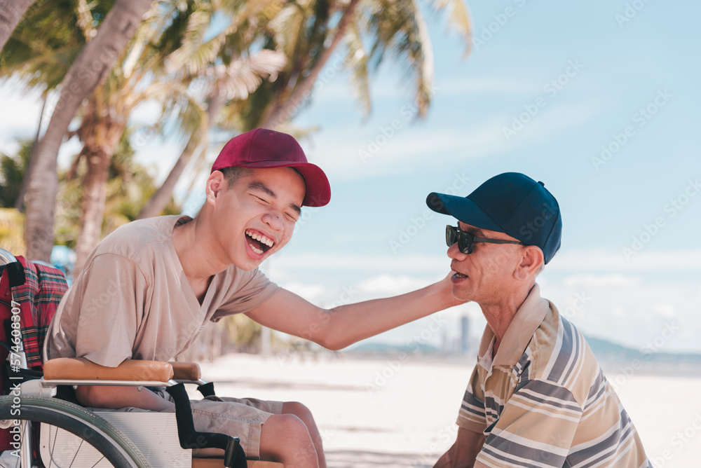 Naklejka premium Young man with disability on wheelchair and father or volunteer or caregiver at happy time on the beach with Family Caregiving, Travel and vacation in summer, Positive photos, mental health concept.