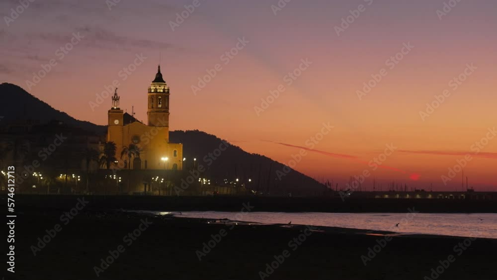 Red sunset twilight sea coast with a church silhouette of hills and birds flying Red sunset twilight sea coast with a church silhouette of hills and birds flying