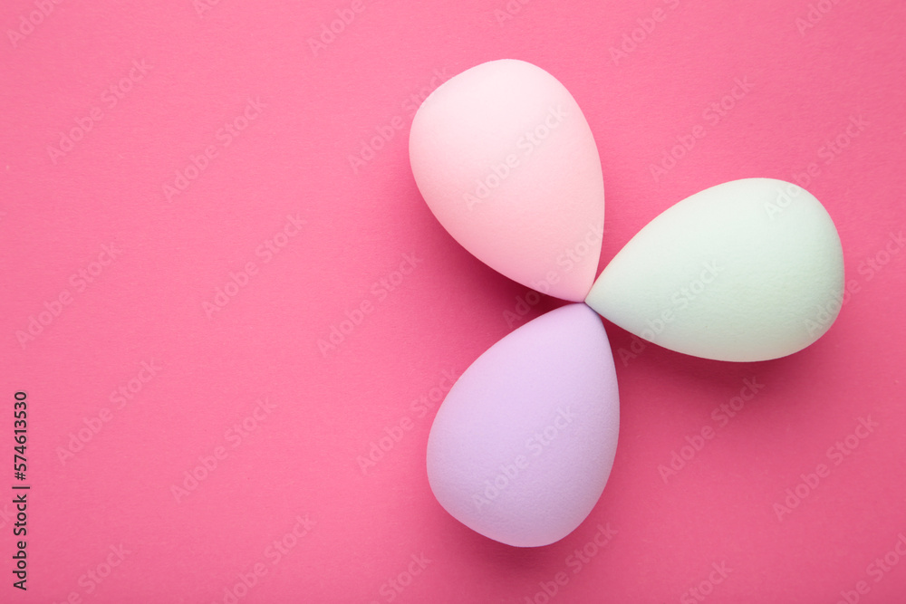Beauty blender on pink background. Bright sponges for make-up cosmetics. Makeup products. Beauty concept.