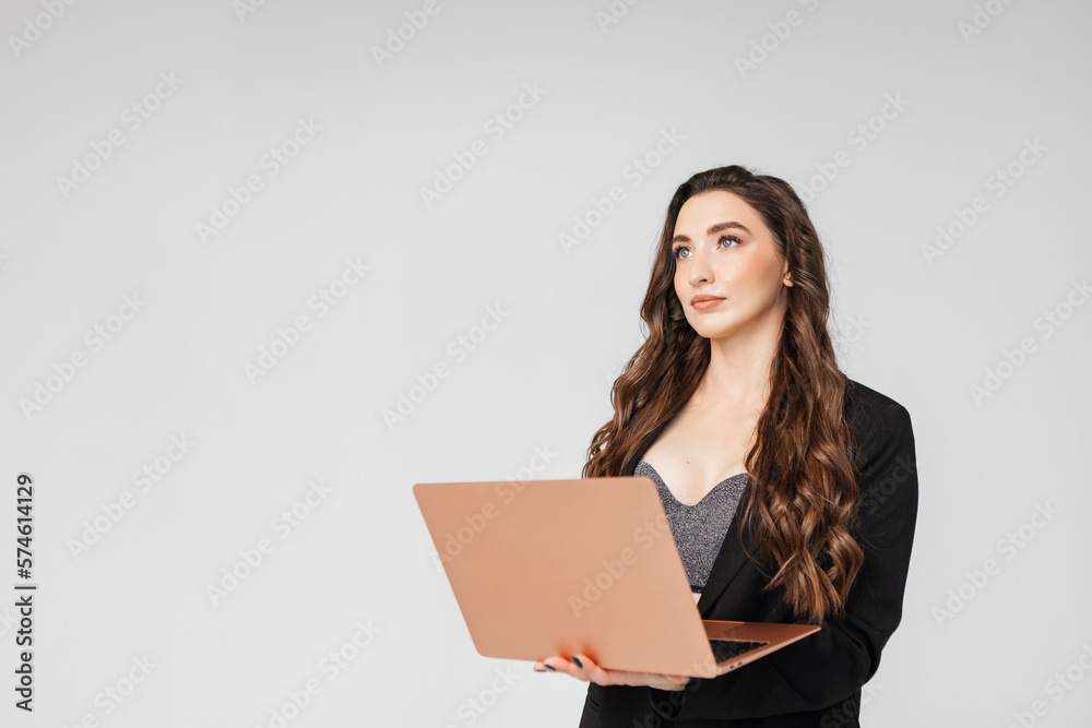 Young businesswoman using laptop against white background, copy space