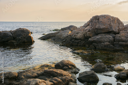 seashore with rocks at sunrise