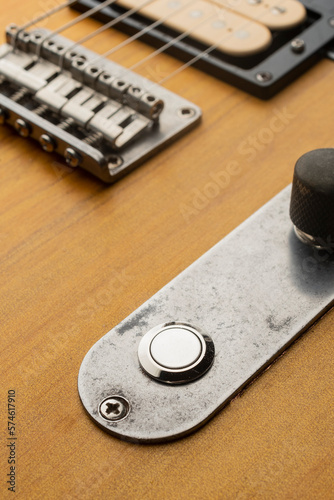 Killswitch button mounted on the control plate of an electric guitar