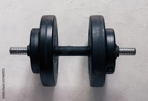 dumbbells on a gray concrete floor in the gym. Fitness or bodybuilding concept. top view with lots of copy space 