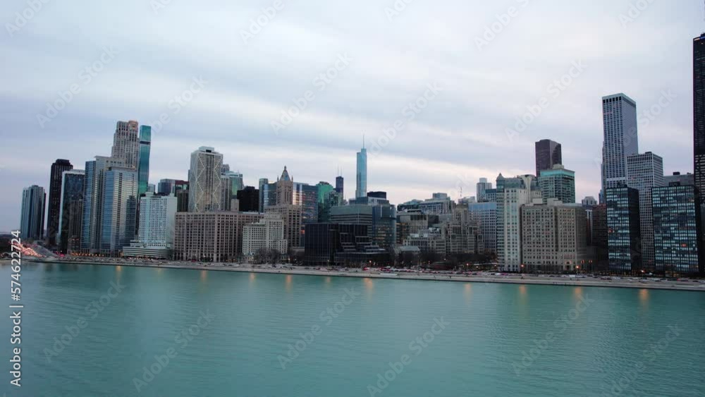 revealing beautiful chicago while flying sideways at the sunset above Lake Michigan Water. Aerial 4k USA revealing beautiful chicago while flying sideways at the sunset above Lake Michigan Water. Aerial 4k USA