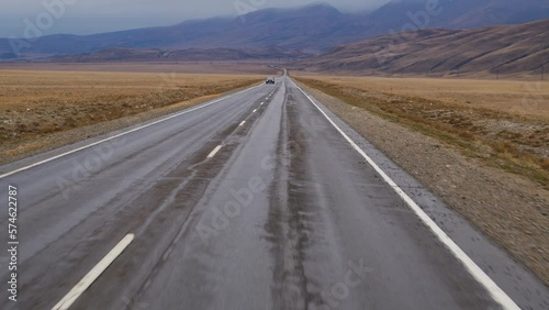 Wallpaper Mural Car is driving on asphalt road through valley. View of highway from drivers seat. Movement of automobile on roadway, surrounded by steppe, hills in autumn. Voyage, trip, travel, tourism Torontodigital.ca