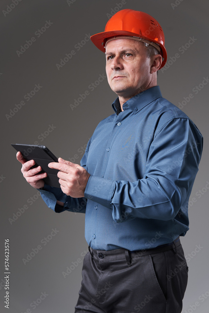 Engineer in hardhat with a tablet Engineer in hardhat with a tablet