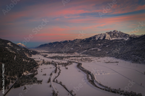 Sunset panoramic view of the top of Waidegg near Tressdorf on the border between Italy and Austria. Nassfeld ski resort in 5km. January 2022, drone aerial shot. photo