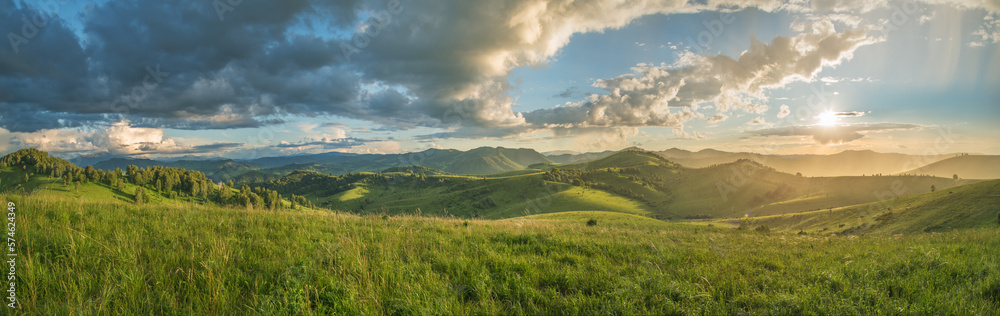 Evening rural landscape, the setting sun, sunset, spring nature, meadows and hills