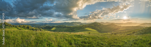 Evening rural landscape, the setting sun, sunset, spring nature, meadows and hills