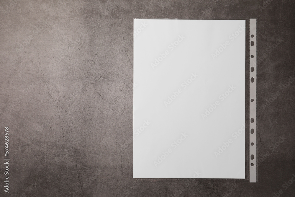 Punched pocket with paper sheet on grey table, top view. Space for text Punched pocket with paper sheet on grey table, top view. Space for text