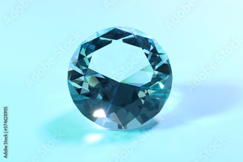 Beautiful dazzling diamond on light blue background  closeup