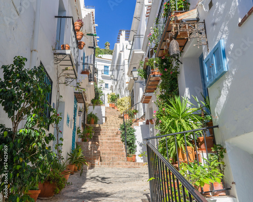 Street of white houses with flowers and flowerpots in the village of Frigiliana. Costa del sol. Malaga. Spain photo