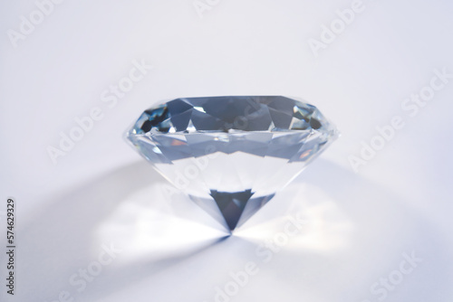 Beautiful dazzling diamond on white background, closeup