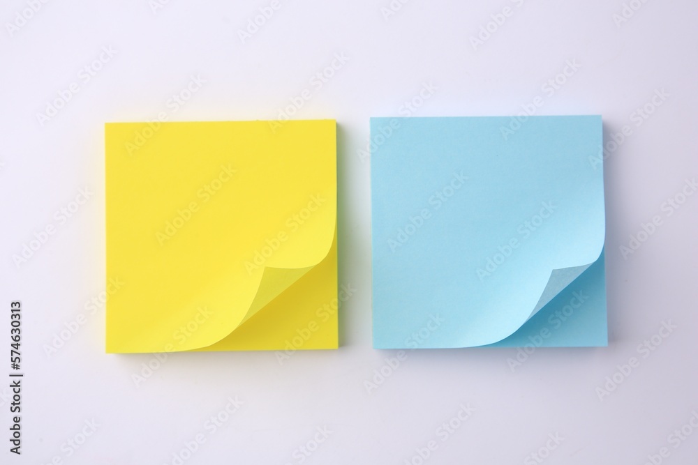 Blank paper notes on white background, flat lay Blank paper notes on white background, flat lay