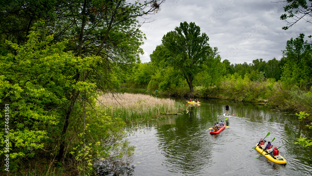 Kayaking on the river. Several kayaks with teams on board compete with each other. Kayaking on the river. Several kayaks with teams on board compete with each other.