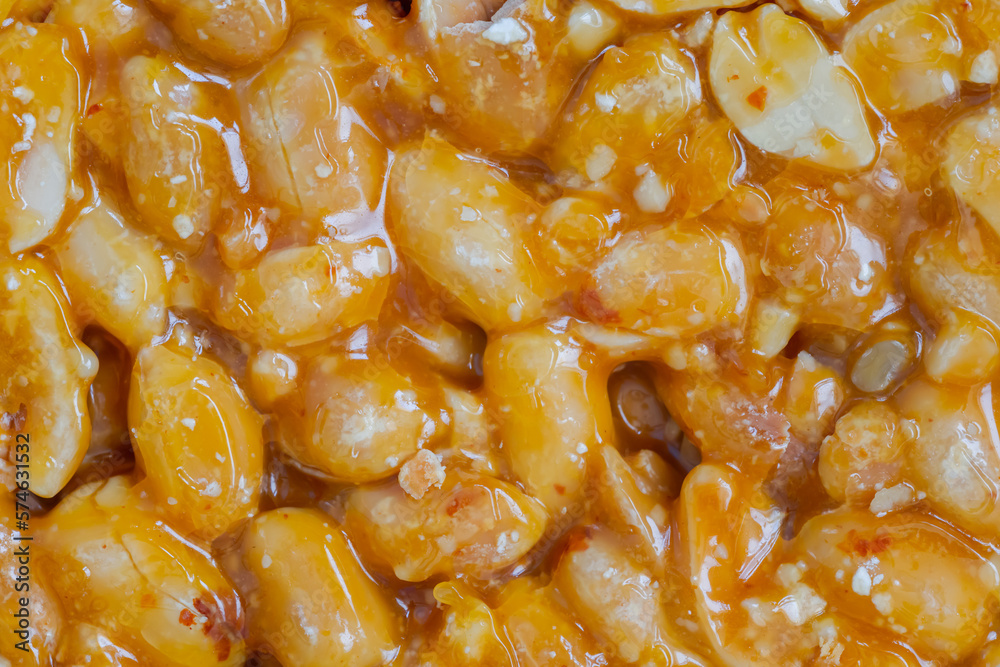 Top view: Gozinaki - caramelized nuts fried in honey - orange granola peanut bar - close up, macro. Traditional Georgian cuisine, gastronomy, oriental sweet and food concept Top view: Gozinaki - caramelized nuts fried in honey - orange granola peanut bar - close up, macro. Traditional Georgian cuisine, gastronomy, oriental sweet and food concept