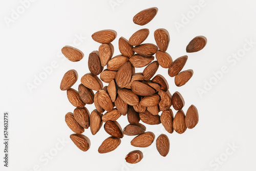 Close-up of Prunus dulcis almond seeds on a white isolated background illuminated by hard light. Image for your design or mockup
