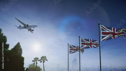Airplane landing in London, UK. A generic passenger plane lowering its landing gears approaching an airport near in United Kingdom. British flag waving in front of city skyline.
