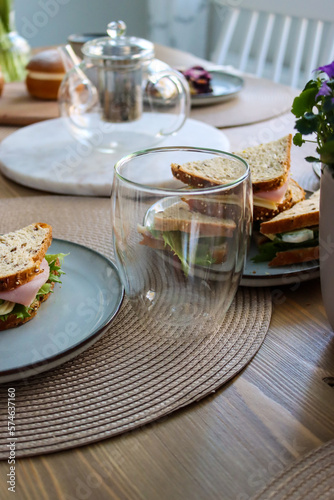 Unwind and Relax with a Delicious Afternoon Tea Time Selection - Enjoy Fresh and Flavorful Sandwiches Served in a Thermoglass at a Beautifully Set Dining Table