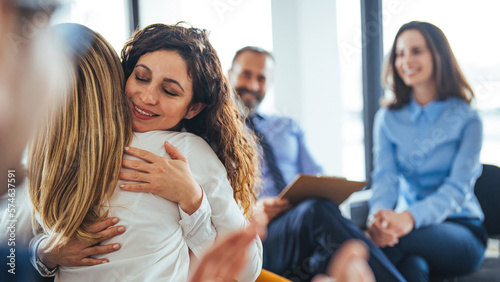Foto A multi-ethnic group of adults are attending a group therapy session