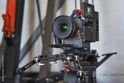 a professional lens is mounted on a video camera with the screen and attachments turned on