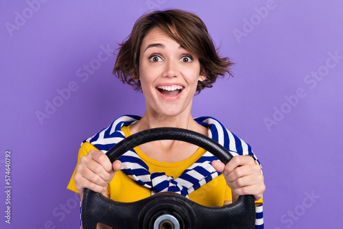 Photo of glad excited lady wear trendy clothes rejoice new car first time driving vehicle isolated on purple color background