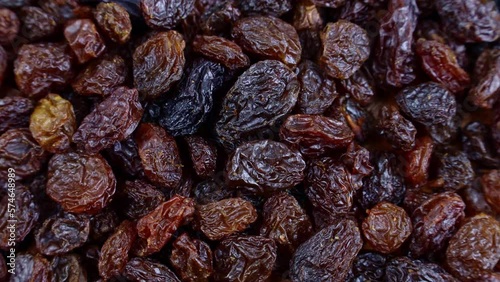 Top view of brown raisins (dried yellow grape) texture circle rotation close up photo