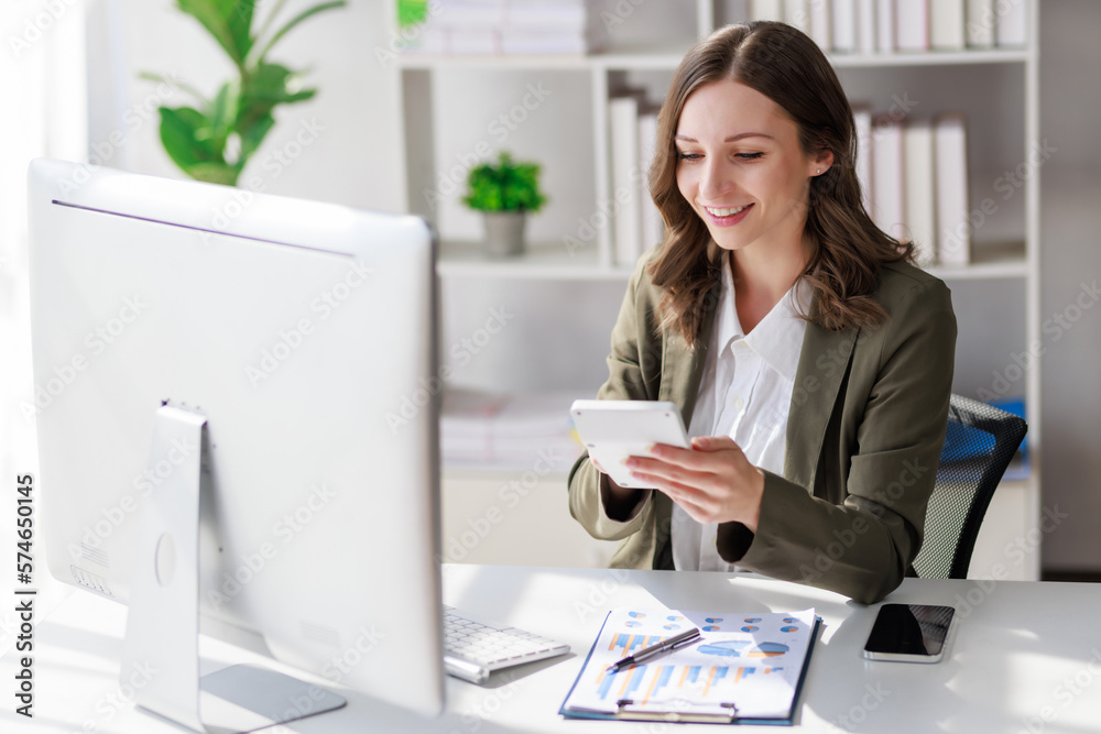 Concept of business investment or working woman, Businesswoman wearing a suit sitting and working on analysis of business investment documents and using calculator to analytic business data. Concept of business investment or working woman, Businesswoman wearing a suit sitting and working on analysis of business investment documents and using calculator to analytic business data.