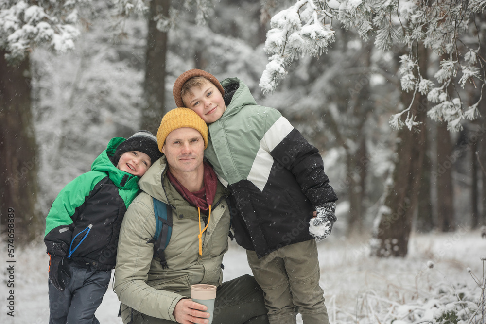 Father and his sons walking in the forest Father and his sons walking in the forest
