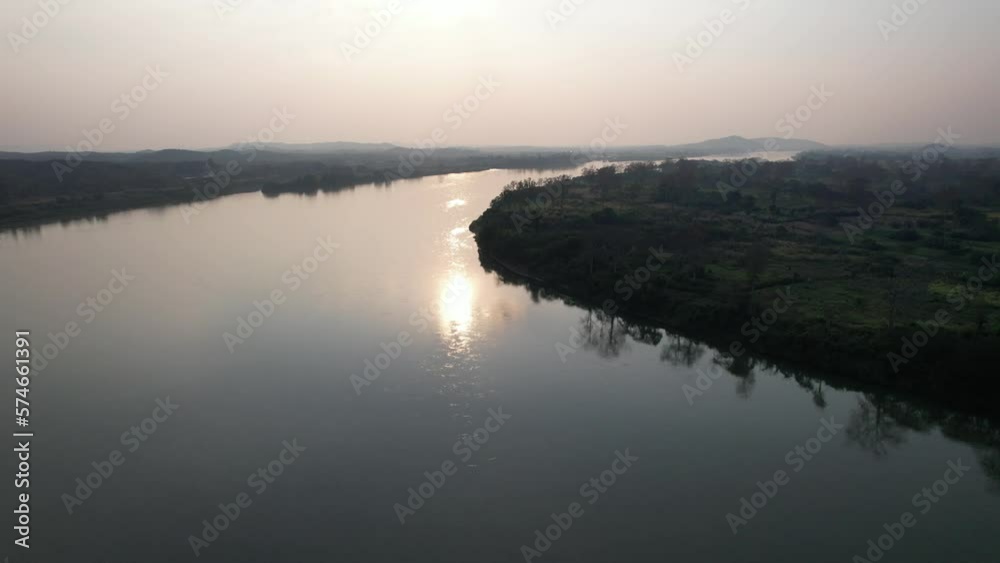 Aerial view of the city by the Mekong river before sunset by drone