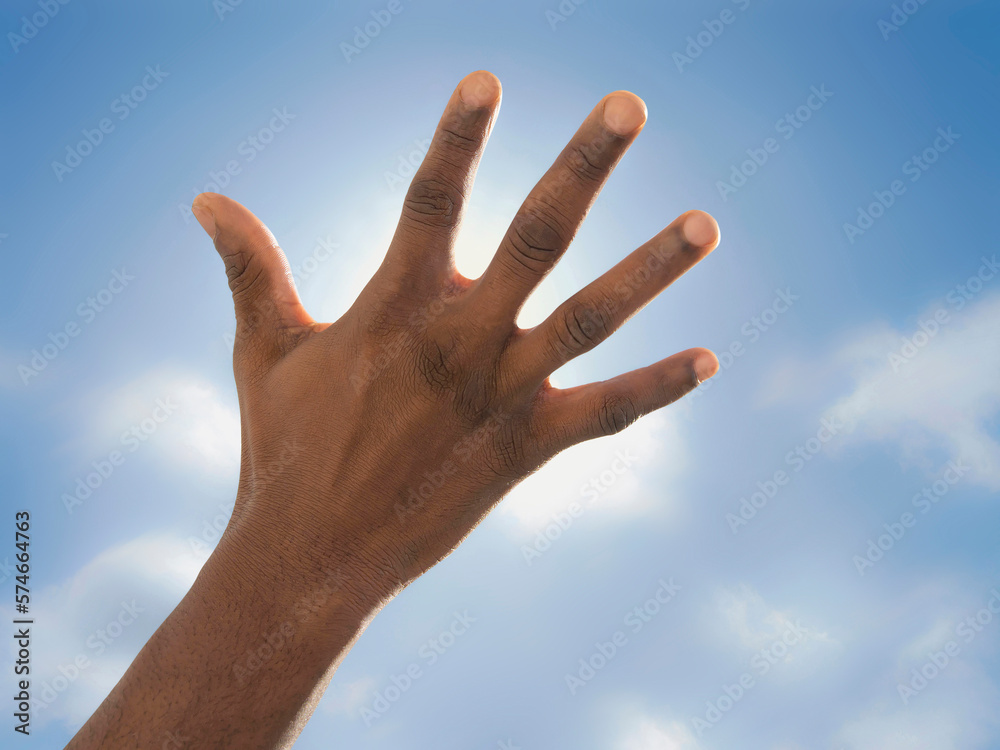 Man hidding the sun with his hand. Symbolic representation of a lack of means when facing climate change. Photo Man hidding the sun with his hand. Symbolic representation of a lack of means when facing climate change. Photo